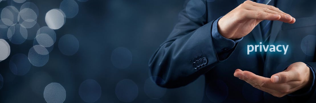 A businessman in a suit holds his hands in front of him, symbolically protecting the word "privacy" against a blurred background.