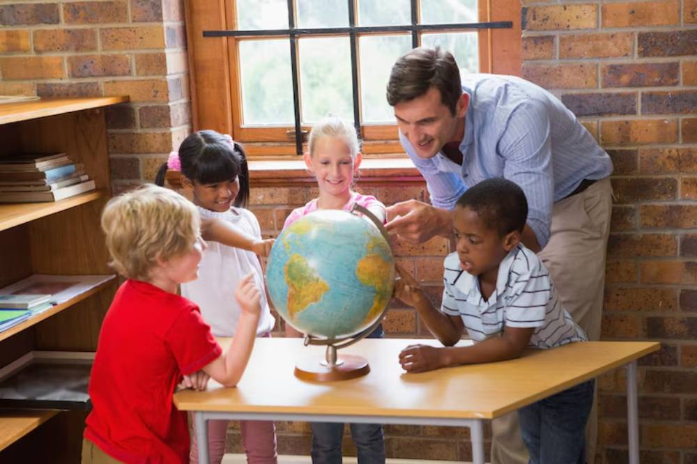 A teacher guides children around a globe in a bright classroom, fostering engagement and curiosity about geography and the world.