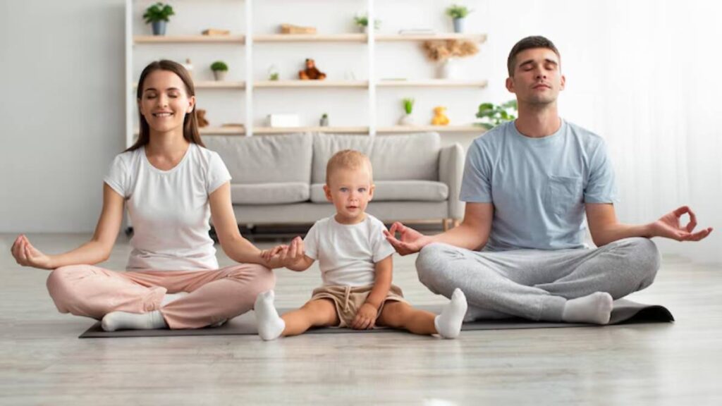 A family practicing mindfulness together, sitting cross-legged on yoga mats in a bright, serene living room.